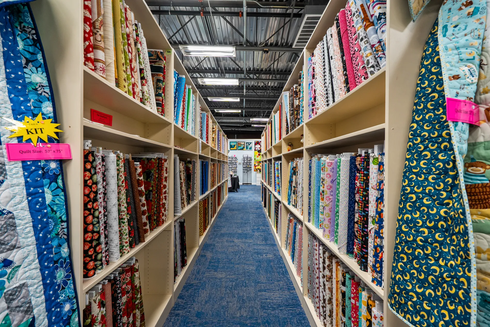 Aisle of quilting fabric bolts inside Fab Fabrics